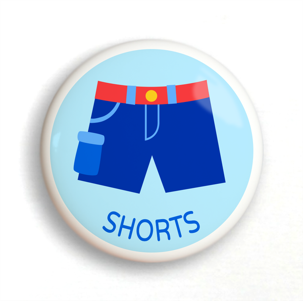 Ceramic drawer knob with boy's shorts on a light blue ground with the word shorts written below