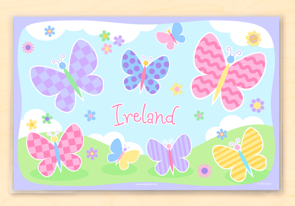 Personalized Kids Placemat with soft color butterflies and flowers on sky and grass background.