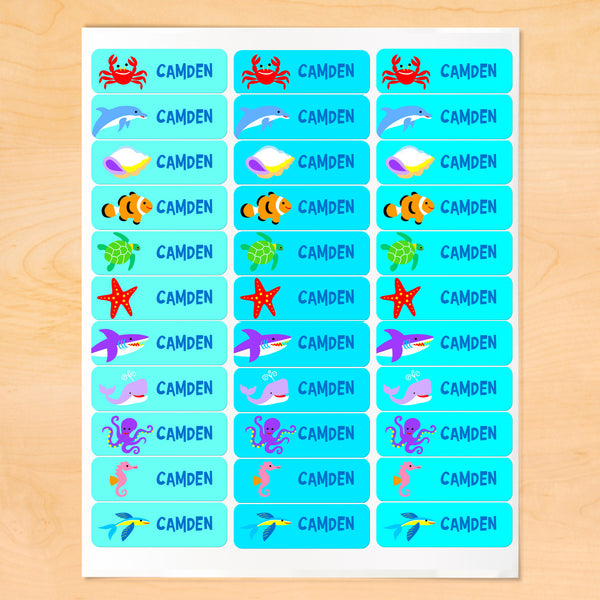 Personalized kids lables with colorful sea creatures on blue-green backgrounds