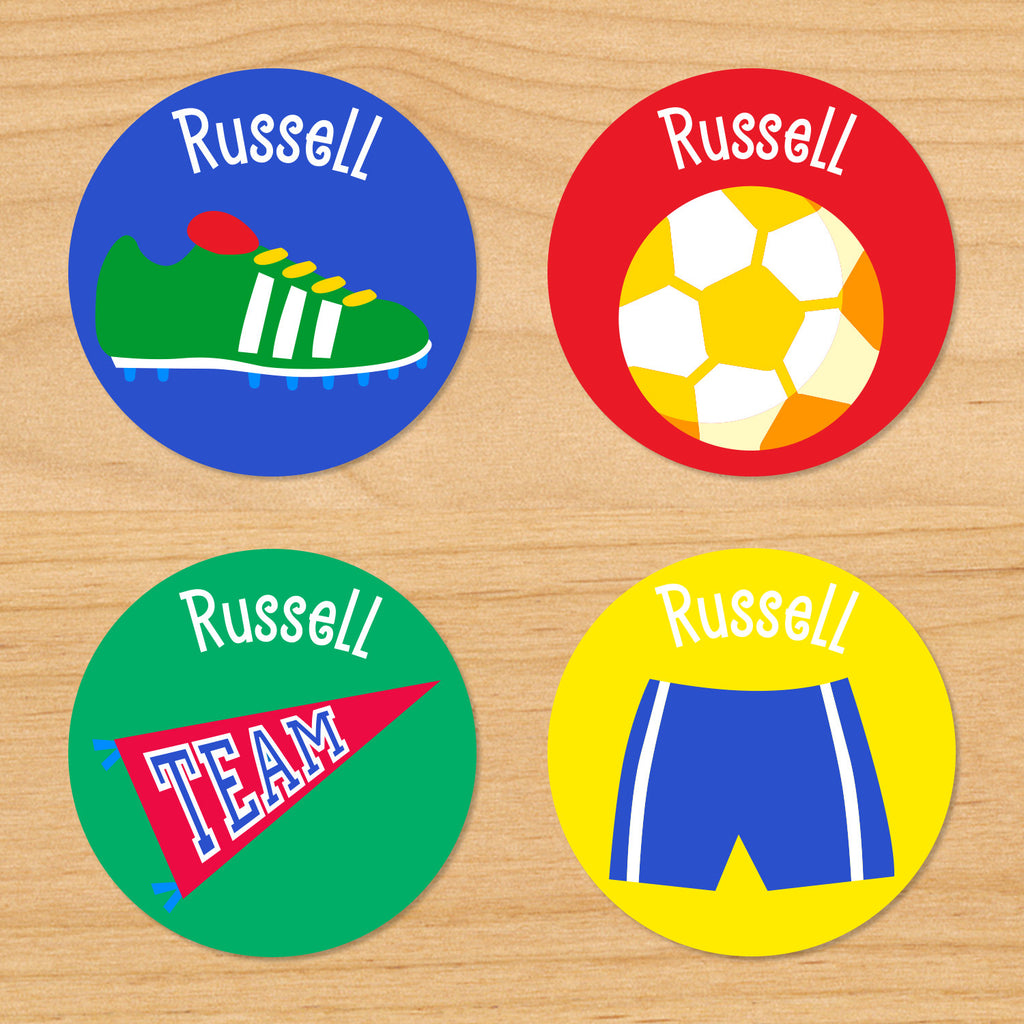 Soccer boys personalized kids round waterproof labels with soccer shorts, pennant, soccer cleats, and soccer ball on blue, red, yellow and green varsity backgrounds