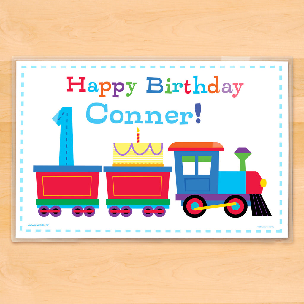 Kids birthday placemat. Colorful train on a white background carrying a birthday cake and birthday number, personalized with child's name.