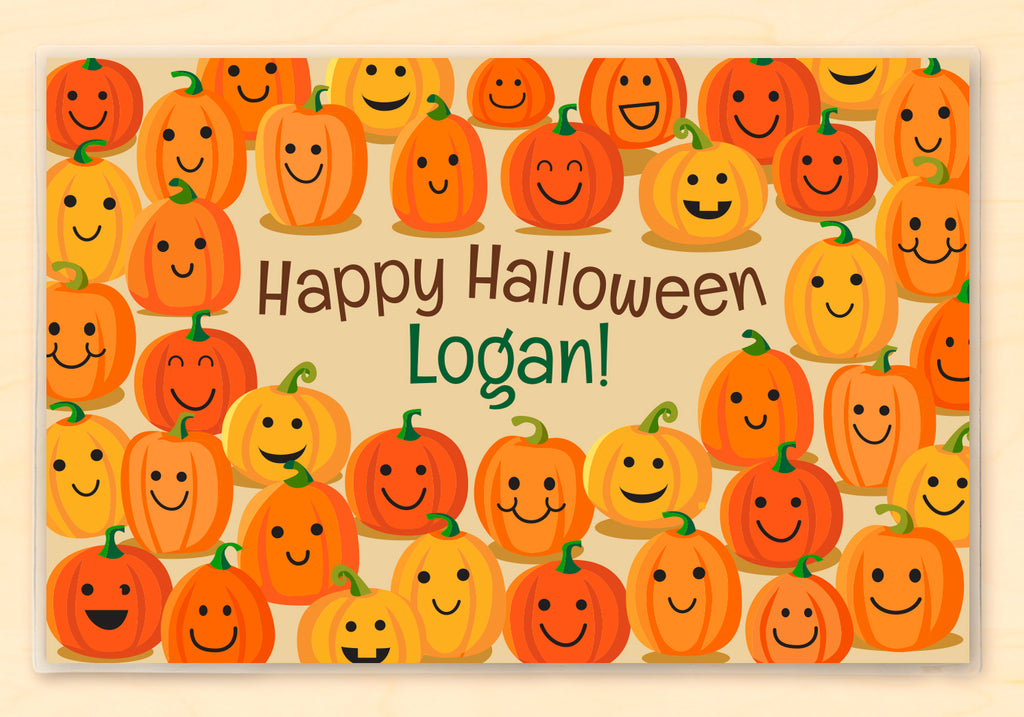 Personalized placemat for kids featuring smiling pumpkins and Jack O'Lanterns