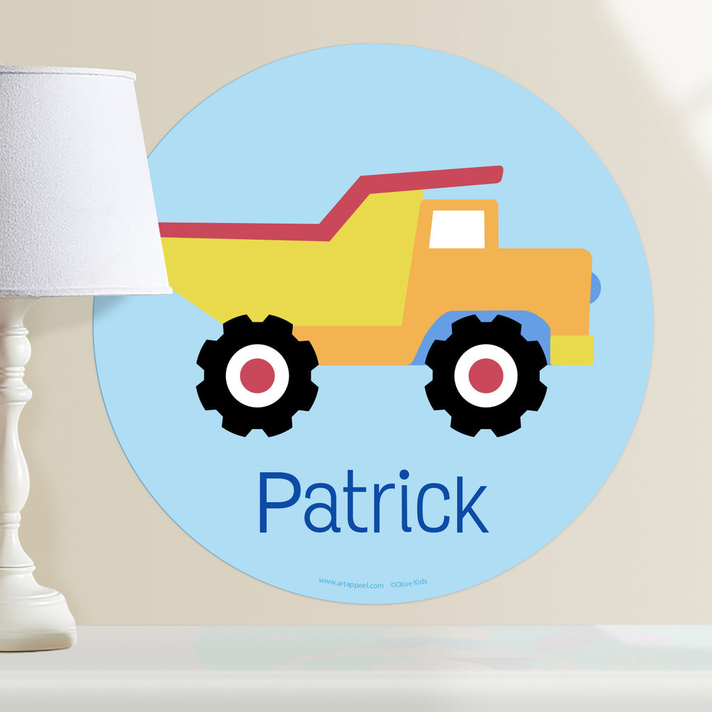 Kids personalized construction themed circular wall decal. Yellow and orange dumptruck on a light blue background.