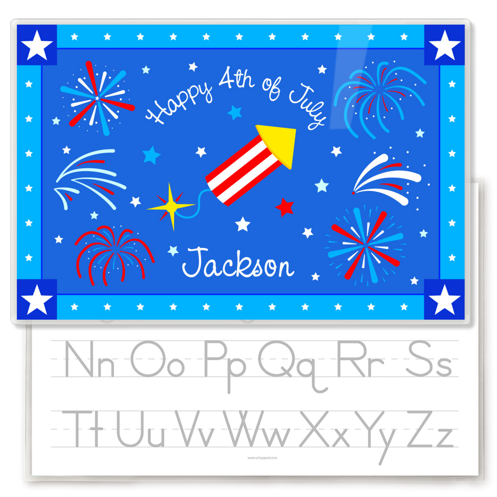 Personalized kids placemat with red, white, and blue fireworks and a firecracker on a blue background, “Happy 4th of July” text, and the name Jackson, with a gray alphabet handwriting practice guide visible on the reverse side.