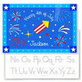 Personalized kids placemat with red, white, and blue fireworks and a firecracker on a blue background, “Happy 4th of July” text, and the name Jackson, with a gray alphabet handwriting practice guide visible on the reverse side.