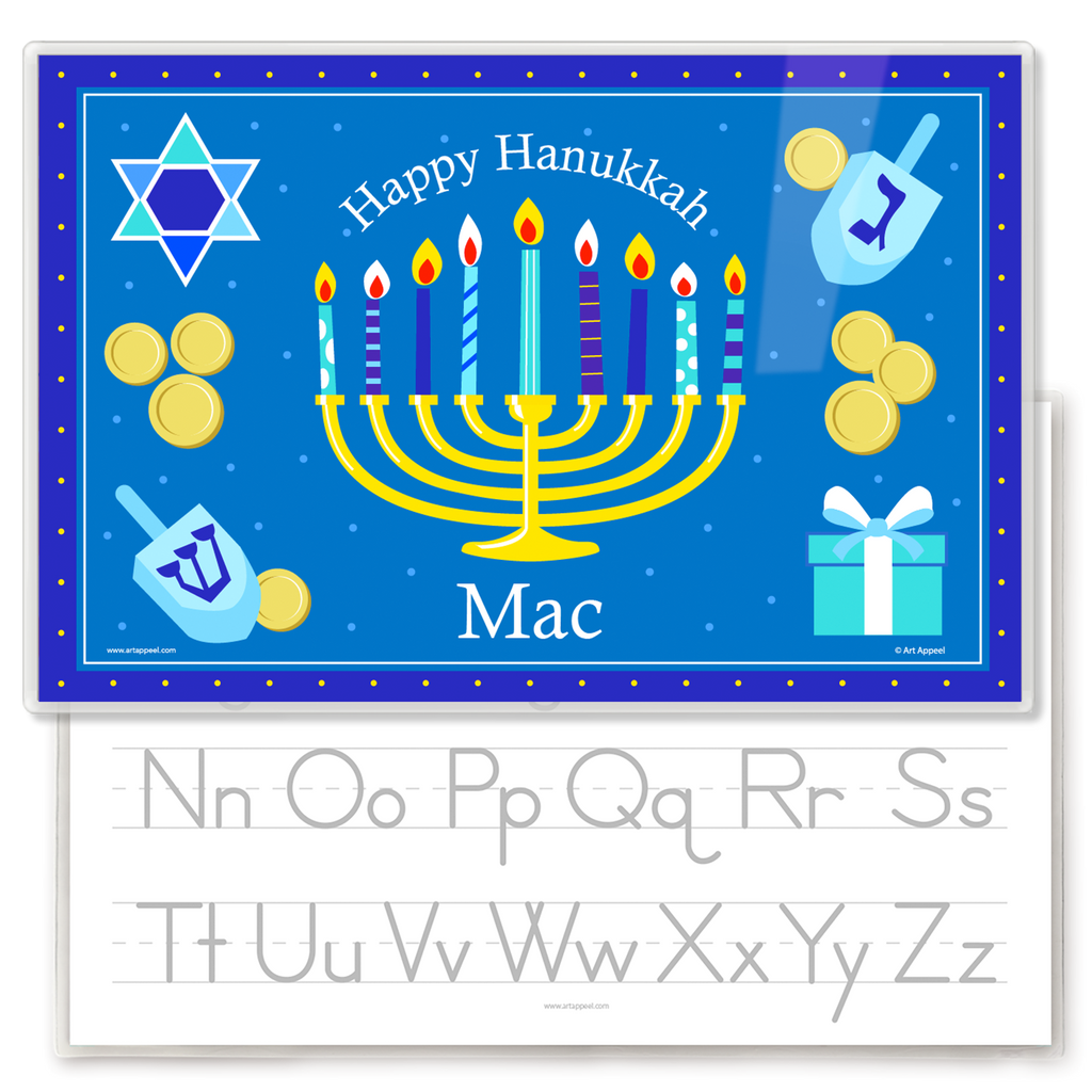 A personalized kids' placemat featuring a Hanukkah theme with a menorah, dreidels, and gelt, and a child's name.