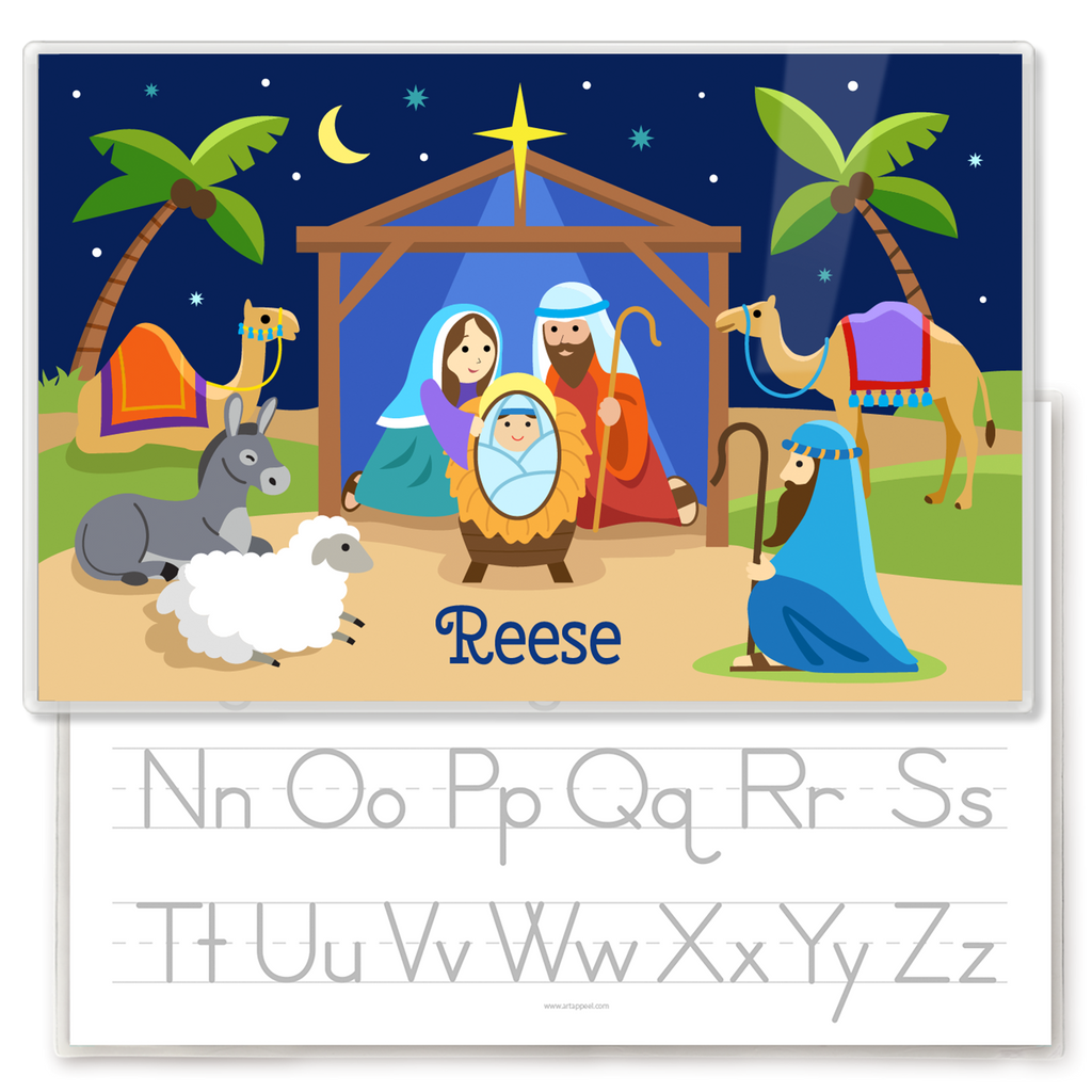 Kids personalized placemat with illustration of Nativity scene with manger, Mary Joseph and Baby Jesus, palm trees, shepherd, animals and the Christmas star.  Personalized with childs name at the bottom. Reverse side has alphabet letters for tracing.
