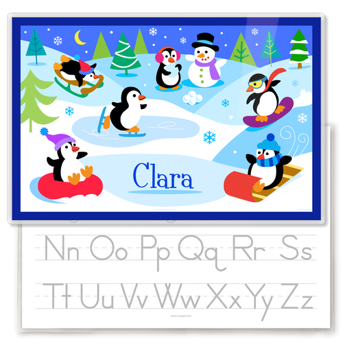 Winter Penguins Personalized Kids Placemat featuring the name Clara and showing a traceable alphabet on the back.