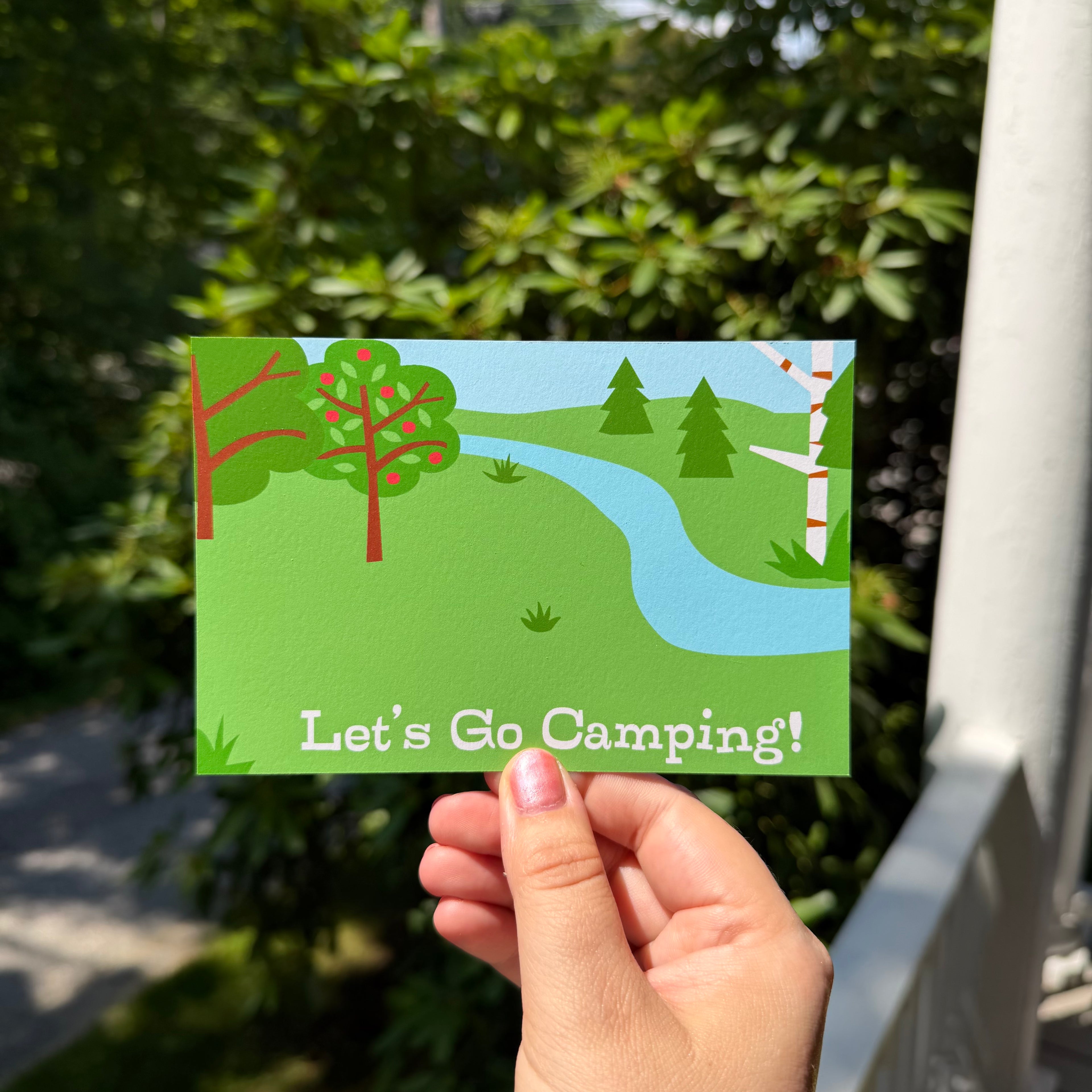 Kids mail club post card back with a wooded campsite scene and the words "Let's Go Camping!"