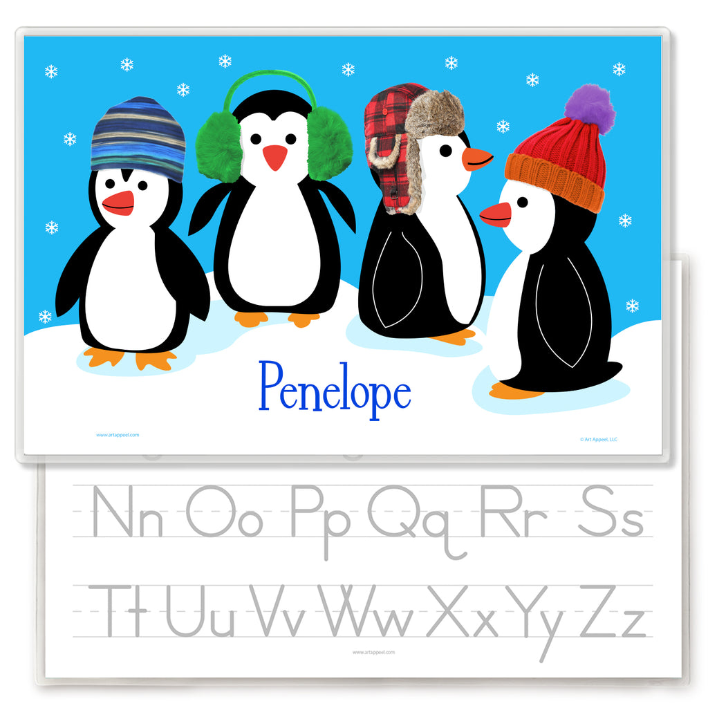 Holiday penguins kids personalized name placemat with knitted winter hats and snow. Reverse side has alphabet letters for tracing.