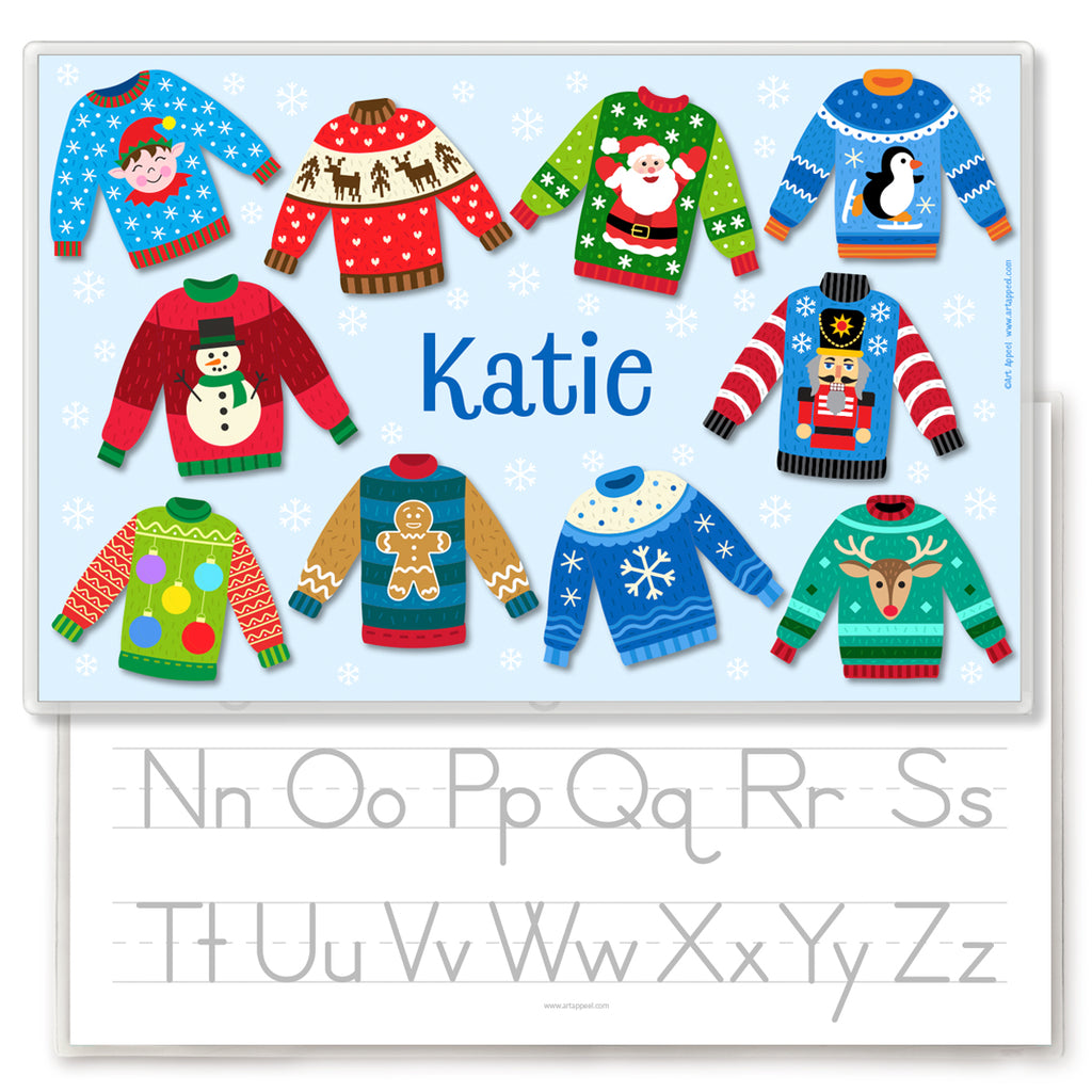 Personalized place mat with 10 ugly christmas sweaters on a light blue background with white snowflakes. Name is in the center in dark blue. Back has alphabet letters for tracing.