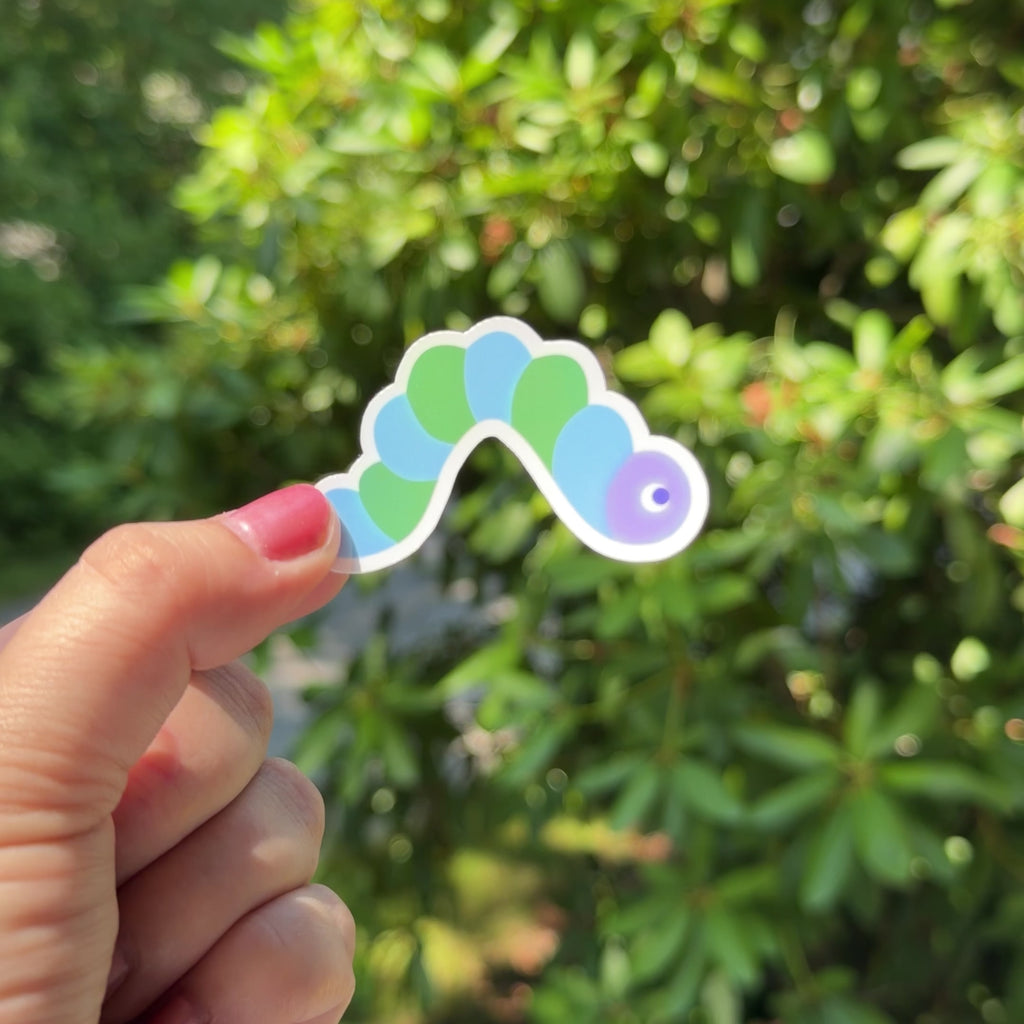 Kids Snail Mail Club holographic caterpillar sticker shimmering in the sunlight