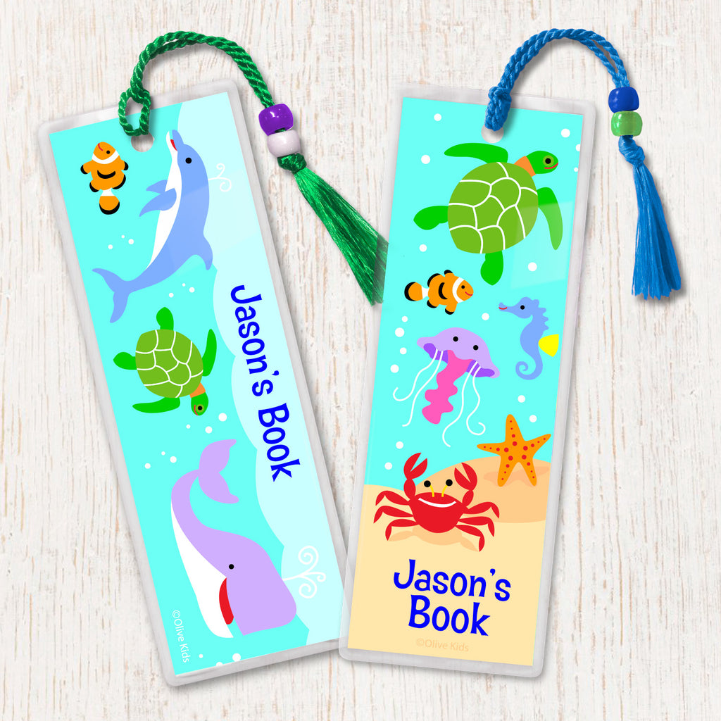 Kids personalized bookmarks with dolphin, sea turtles, whale  and other sea creatures in an underwater scene, decorated with tassel and beads.