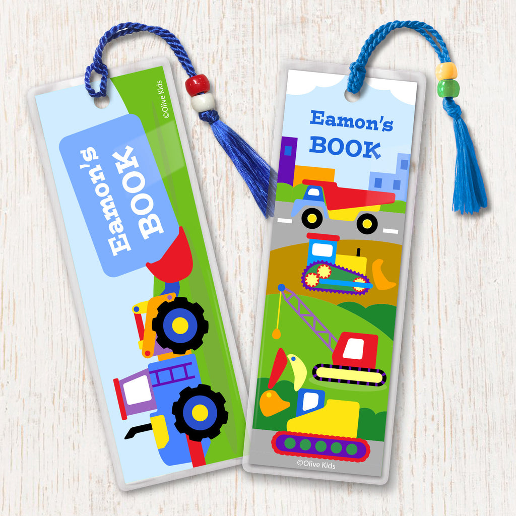 Construction themed kids personalized name bookmarks. Brightly colored trucks on a construction site background, decorated with tassesl and beads.