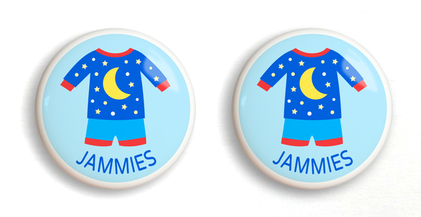 2 ceramic drawer knobs with blue boys pajamas on a light blue ground with the word jammies written below