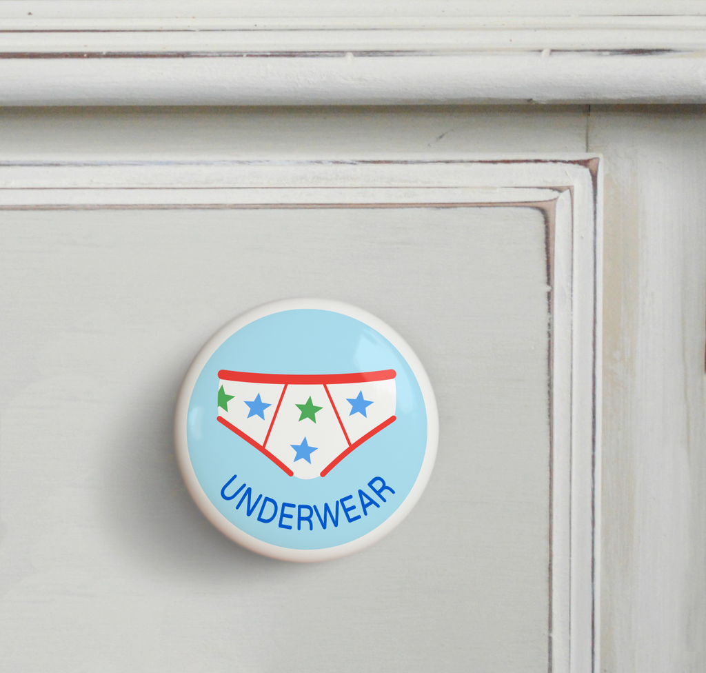 Ceramic drawer knob on a dresser, with boy's underwear  on a light blue ground with the word Underwear written below