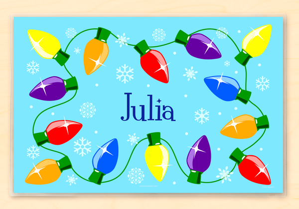 Christmas Lights Personalized Kids Placemat with a string of colorful Christmas lights on a light blue background with snowflakes.  Child's name is in the center in dark blue.