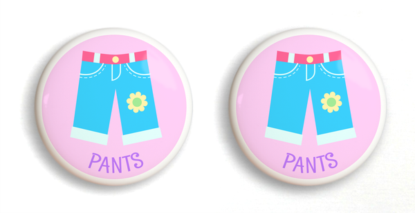 2 Ceramic drawer knobs, girls pants on a pink ground with the word Pants written below