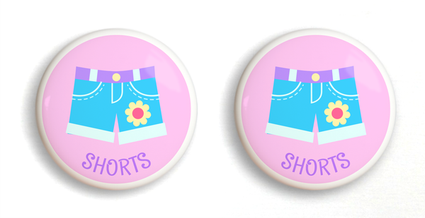 2 Ceramic drawer knobs, girls shorts on a pink ground with the word shorts written below