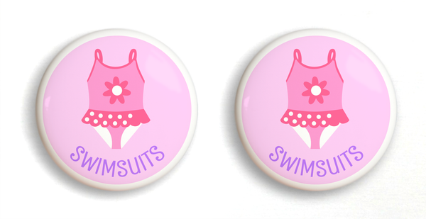 2 Ceramic drawer knobs. Girl's bathing suit on a pink ground with the word Swimsuit written below