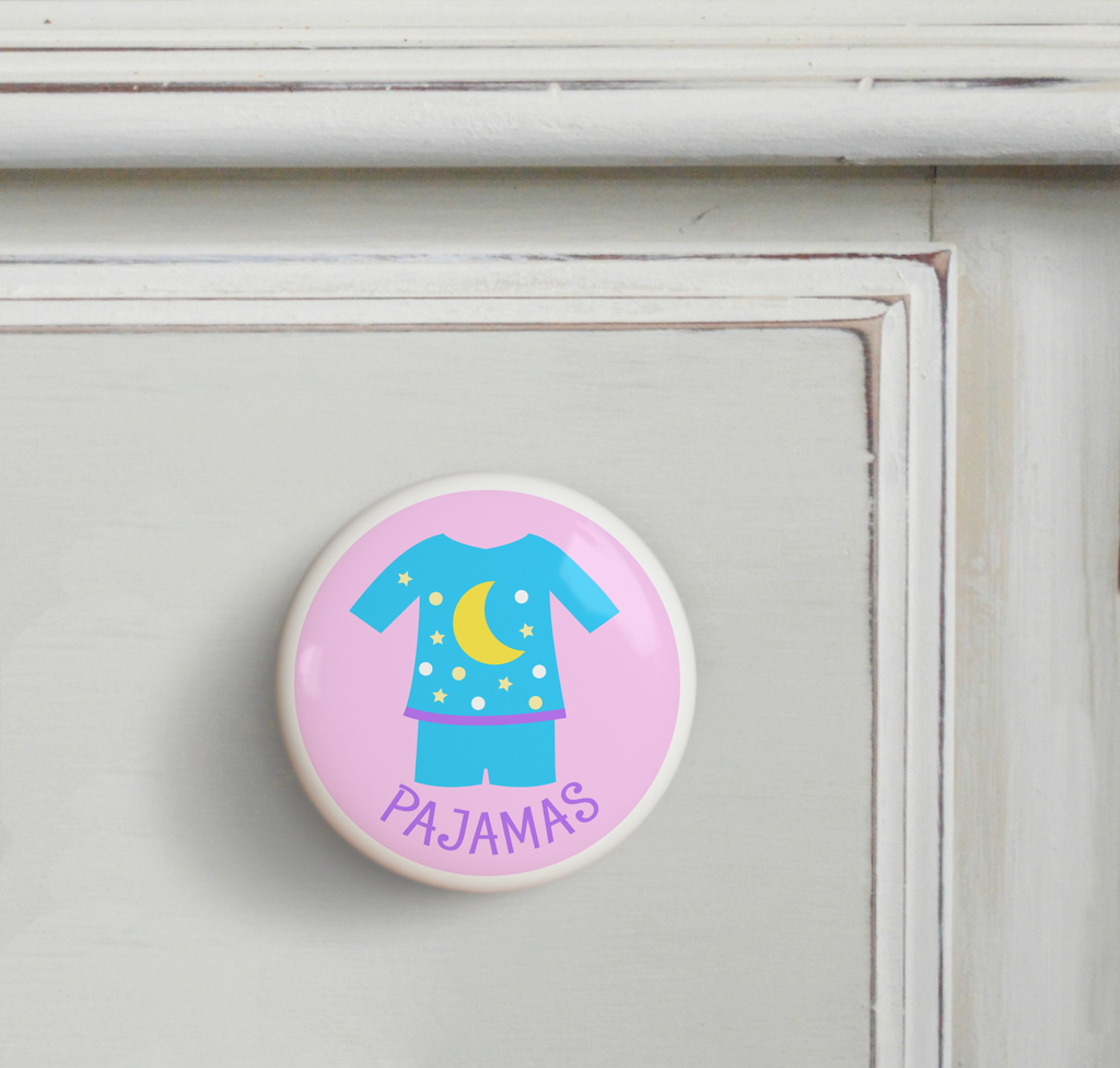 Ceramic drawer knob on a dresser with Girl's Pajamas on a pink background with the word Jammies written below
