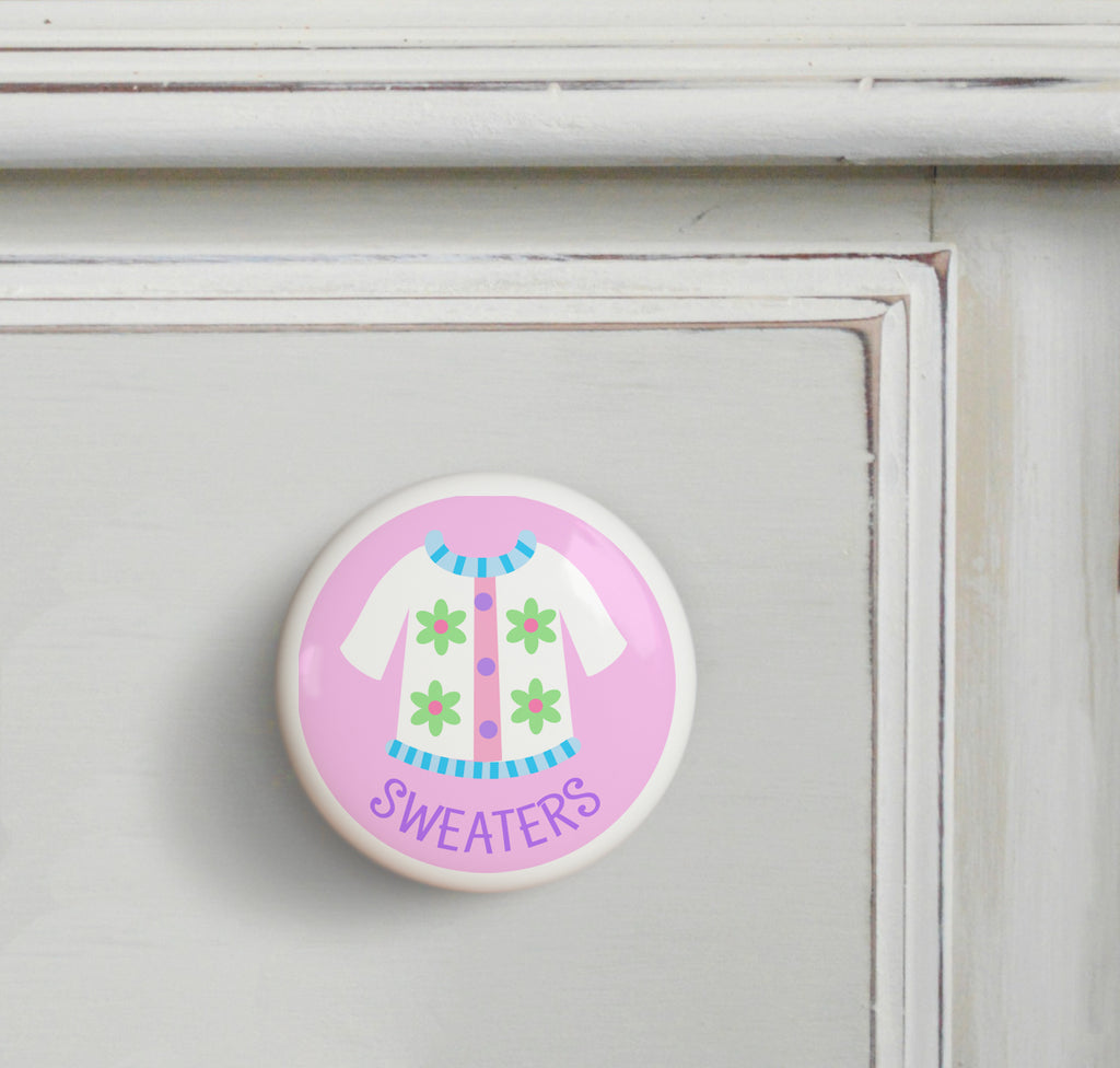 Ceramic drawer knob on a dresser, Girl's white sweater on a pink background with the word Sweaters written below