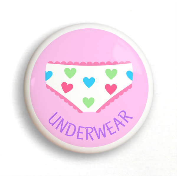 Ceramic drawer knob on a pink background with the word Underwear written below