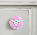 Ceramic drawer knob on a dresser, underwear on a pink background with the word ***s written below