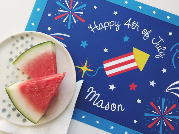 Happy 4th of July patriotic personalized kids placemat with a blue background, fireworks, firecracker, and watermelon slices