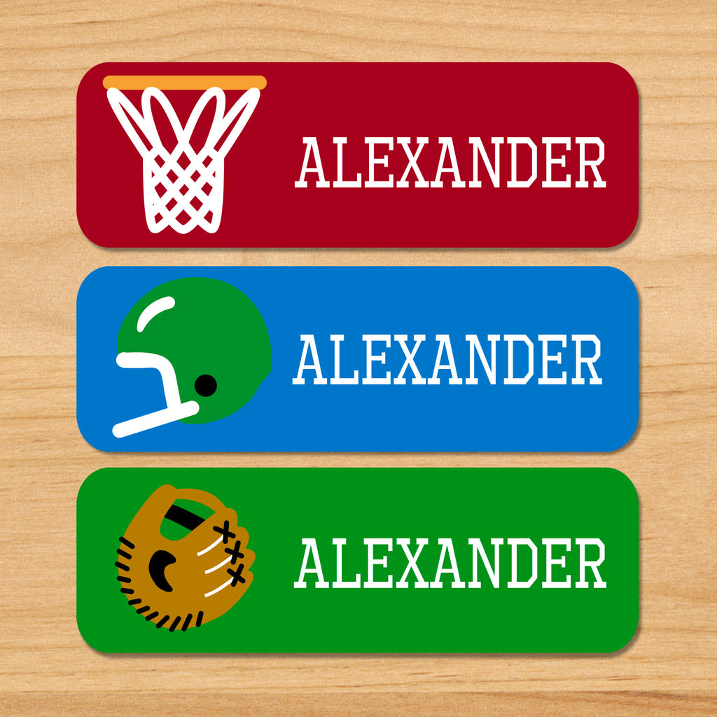 Game on sports kids waterproof labels with kids name, basketball hoop, football helmet and baseball glove on red, green and blue varsity backgrounds