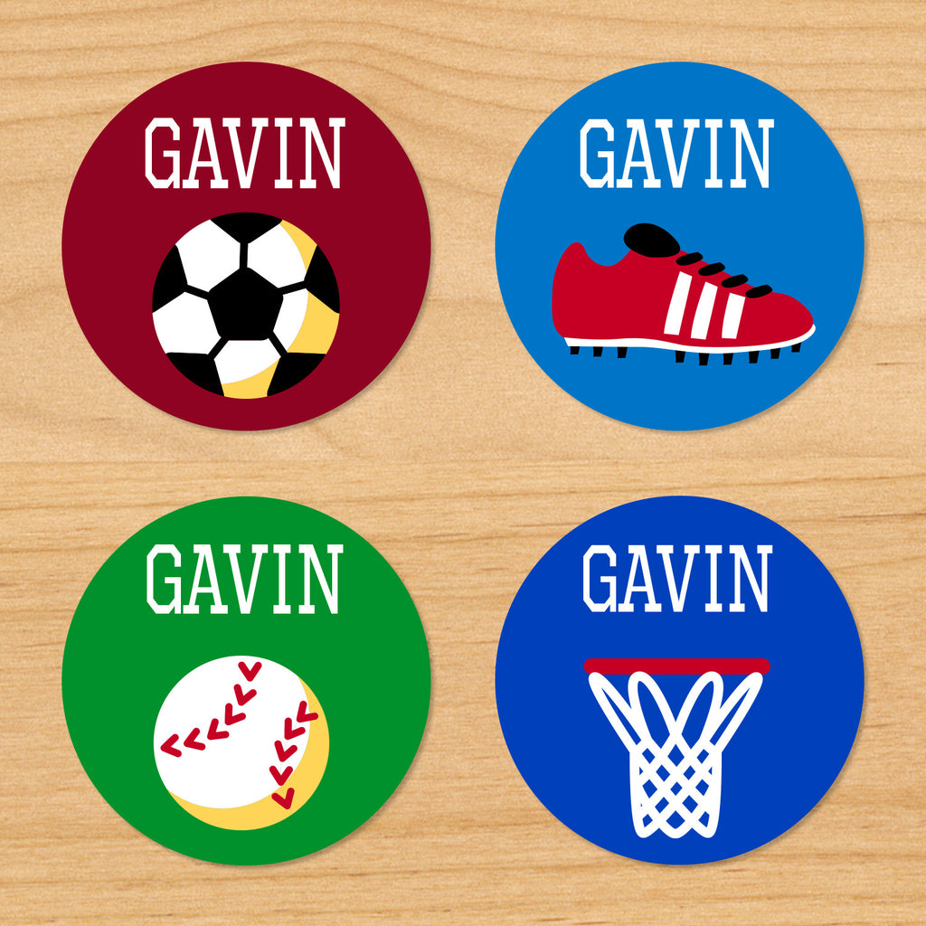 Game on sports kids round boys waterproof labels with soccer ball, soccer cleat, baseball, and basketball net on red, green and blue varsity backgrounds