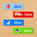 Heroes personalized kids mini waterproof labels with name, ambulance, dalmatian, and motorcycle cop on blue, red, and green backgrounds