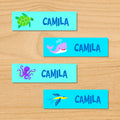 Ocean personalized kids mini waterproof labels with name, sea turtle, whale, octopus, and fish on blue ocean water background