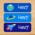 Out of this world space kids personalized waterproof name labels with earth, planet, and spaceship on blue space background