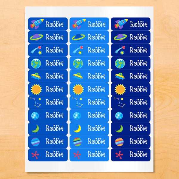 Personalized kids lables with rocket ships, planets, and stars on blue backgrounds