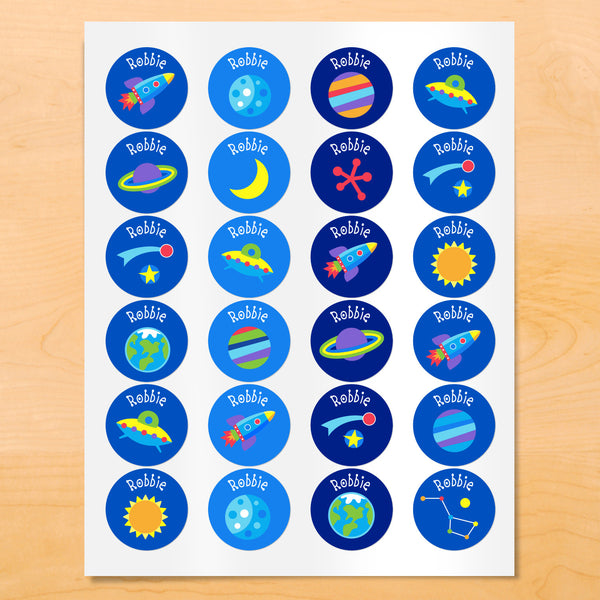 Personalized kids round lables with rocket ships, planets, and stars on blue backgrounds