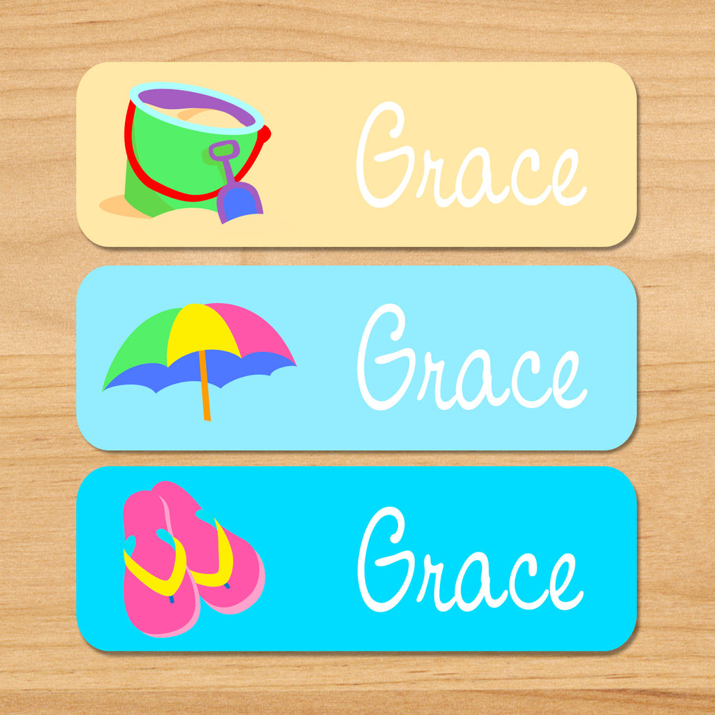 Summer beach personalized kids name waterproof labels with sand, bucket, umbrella, and flipflops on sand and blue background