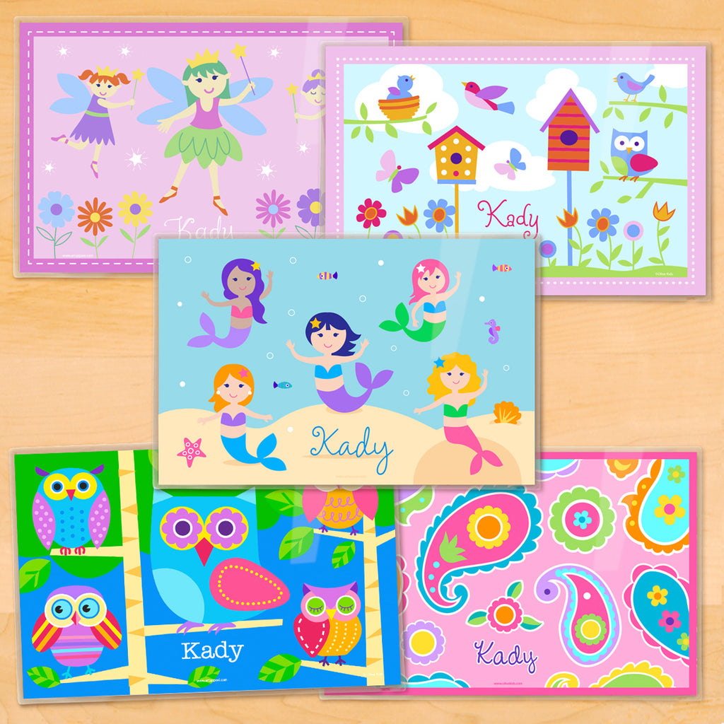 Set of 5 personalized placmats. One each of Mermaids in an ocean scene, Owls on a blue background, Fairies on pink background, Birds and Birdhouses, and Pink Paisley.