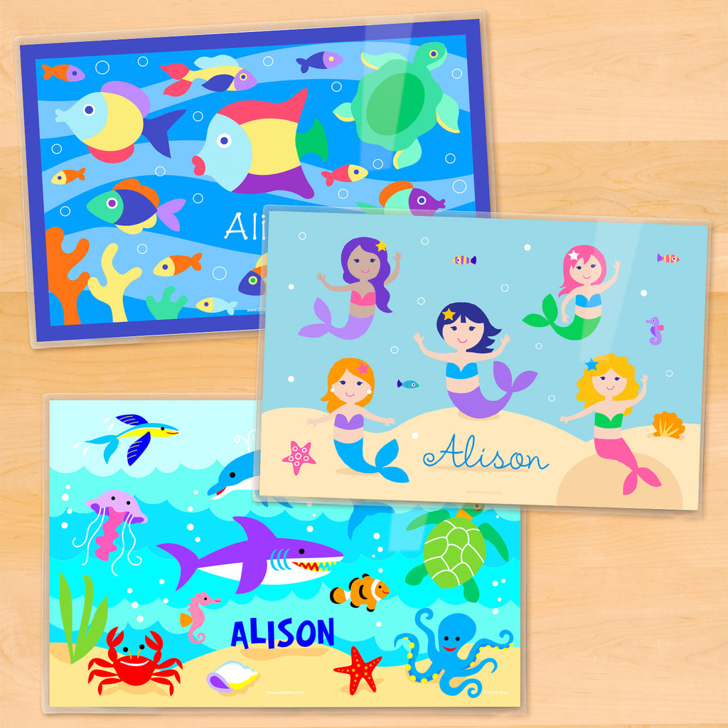 Girls personalized ocean themed placemats with colorful mermaids, playful dolphins, and tropical fish under the sea