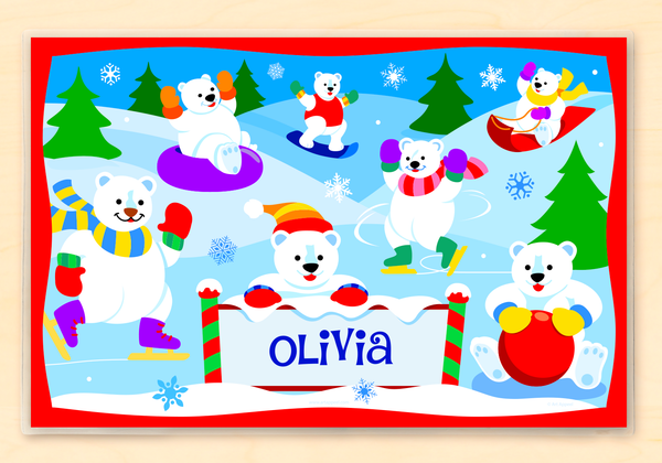 Kids personalized place mat of polar bears sledding, ice skating, and playing in the snow. Place mat is personalized with child name at the bottom center, with a polar bear peeking over it. 