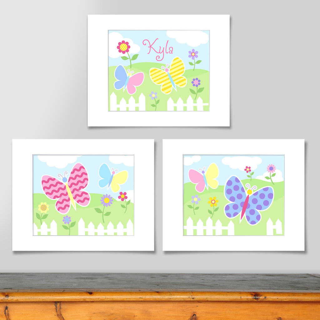 Set of 3 coordinating butterfly prints. Softly colored butterflies in landscape with picket fence and flowers.One print is personalized with childs name.