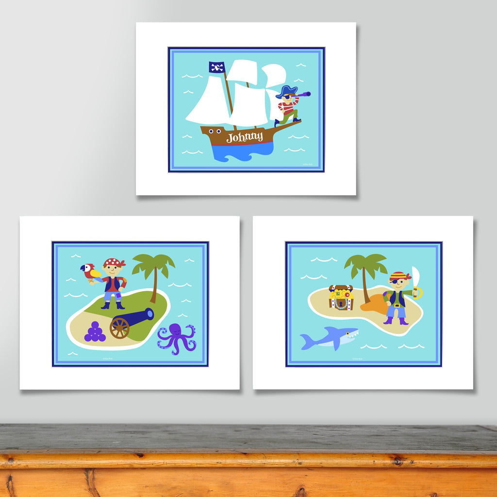 Prints include personalized pirate ship, pirate and treasue chest on an island, and pirate with a parrot on an island. All on sea blue ocean and waves background.