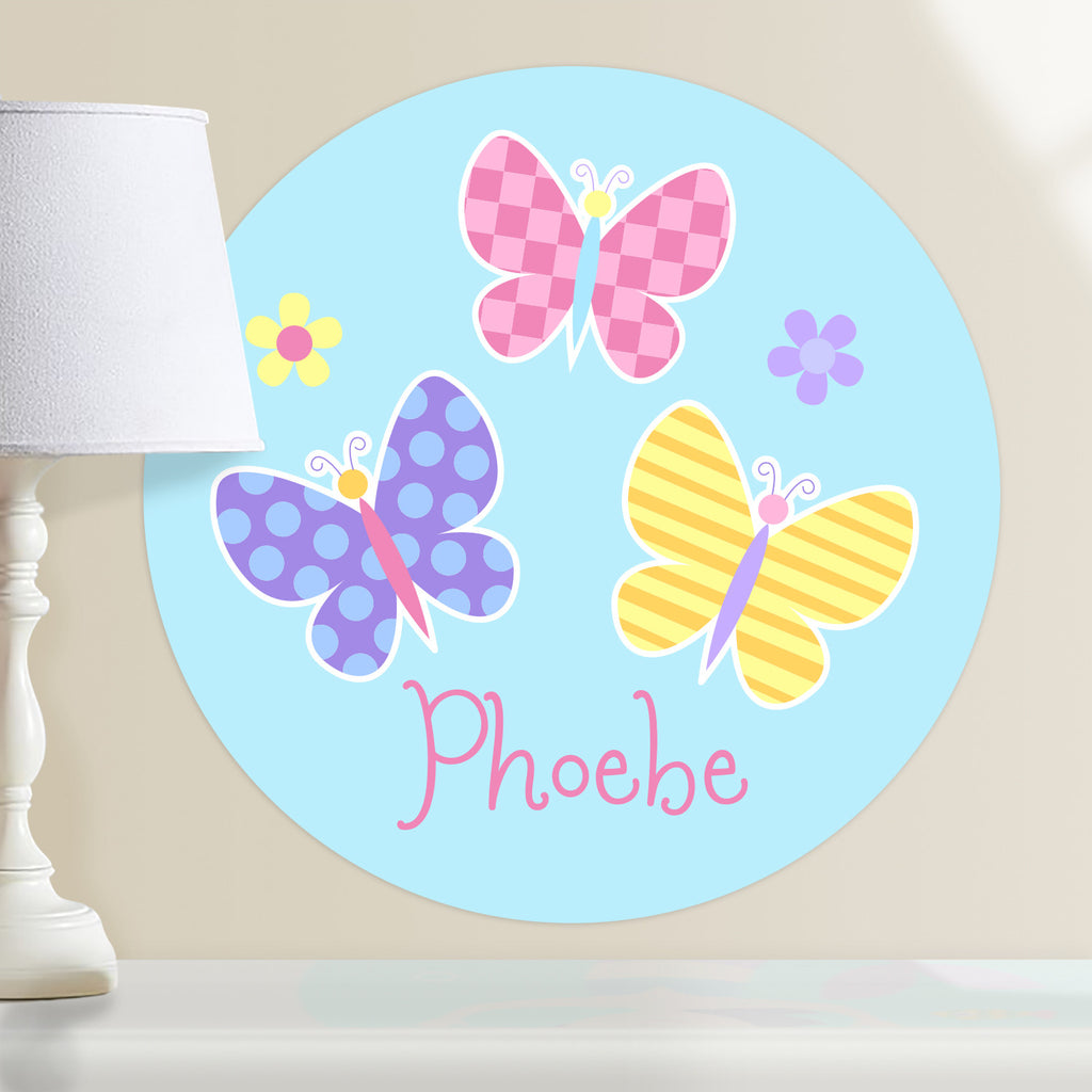 Kids personalized circular wall decal. Pink, blue and yellow butterflies on a light blue background.