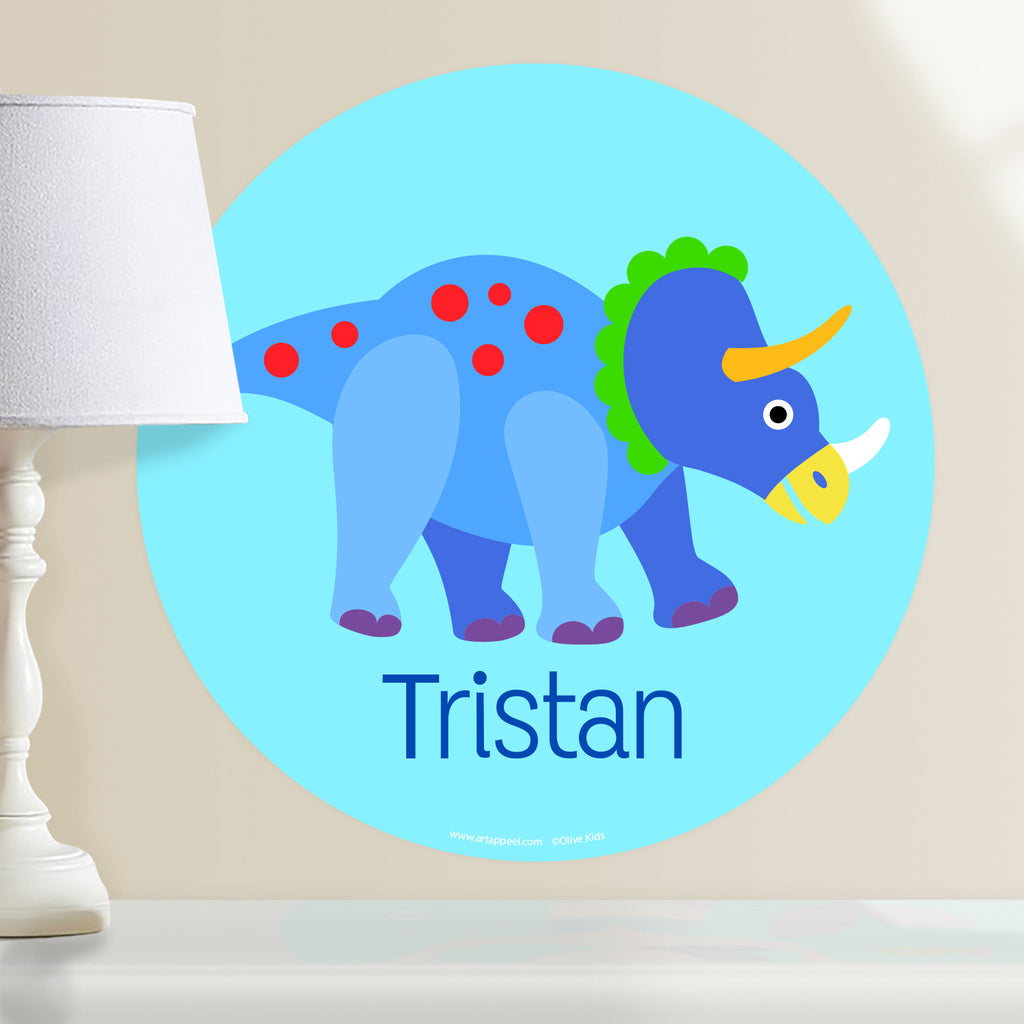 Kids personalized dinosaur circular wall decal. Blue and red dino on a light blue background.